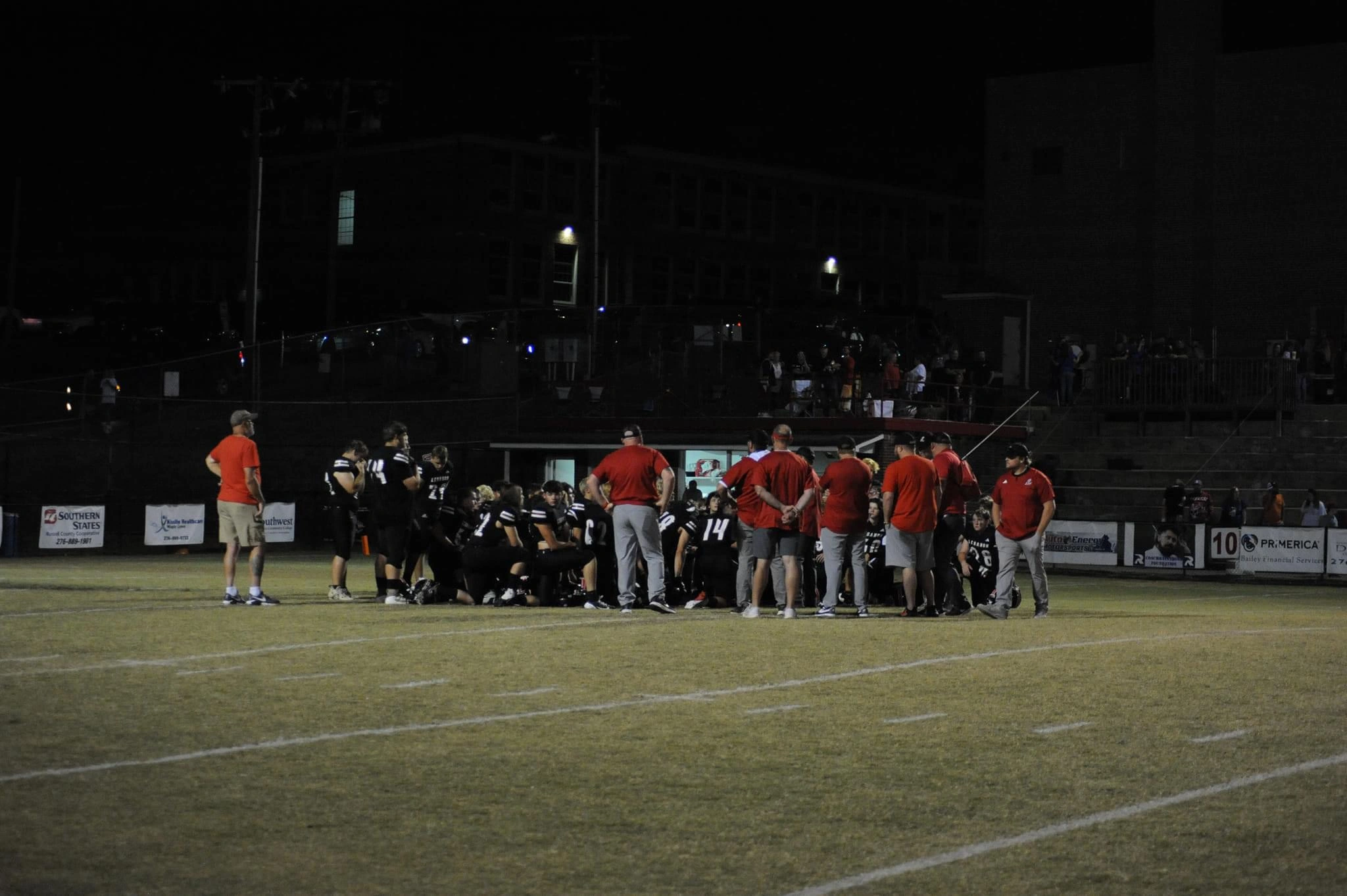 Players in a football huddle